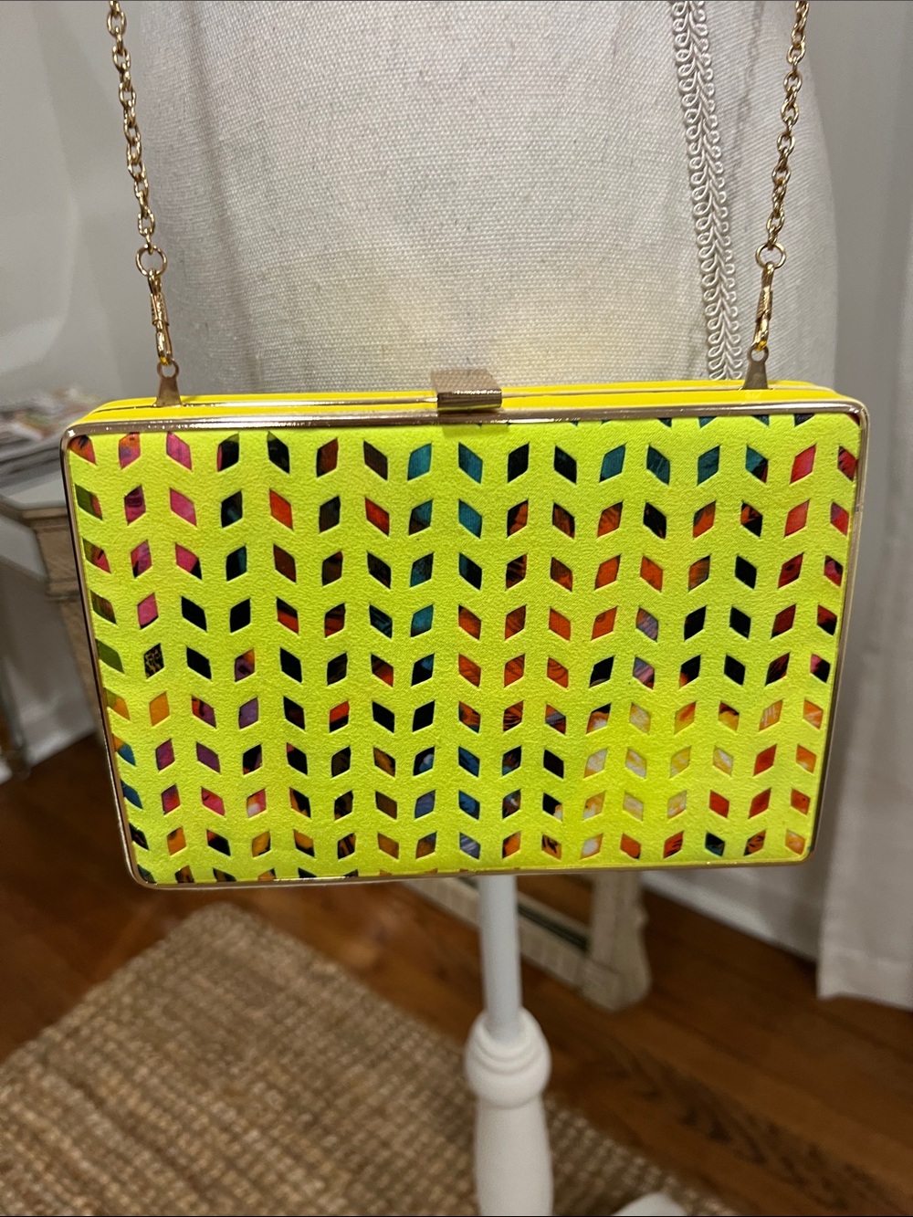 Hard-case geometric laser-cut overlay clutch purse with a gold-tone chain strap